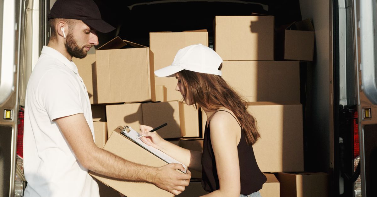 Courier team loading packages into a van, managing logistics and distribution tasks efficiently.
