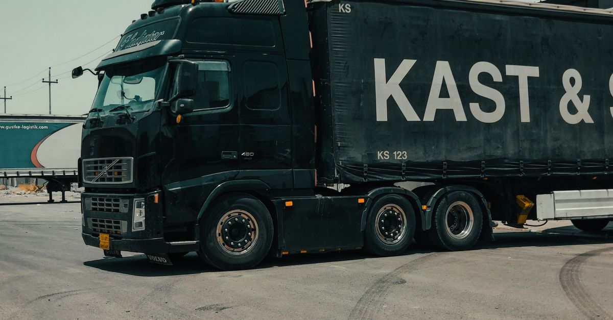 A large industrial truck parked in an urban setting, showcasing transportation industry visuals.